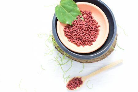 Achiote, annatto, bixin, urucÃº or onoto is a natural red pigment for colorants and cooking displayed in seed containersの写真素材