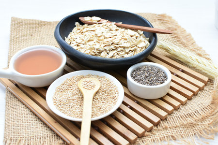 Quinoa cereal accompanied by quinoa seeds and honey on a light background
