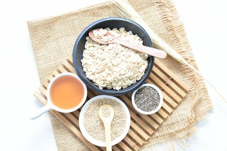 Quinoa cereal accompanied by quinoa seeds and honey on a light backgroundの写真素材