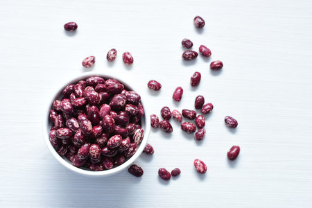 (Phaseolus vulgaris) Red beans displayed in different containers on flat bottoms