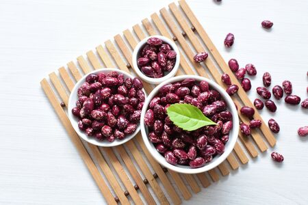 (Phaseolus vulgaris) Red beans displayed in different containers on flat bottomsの写真素材