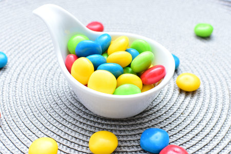 Variety of blue, red, green, yellow multicolored candies displayed in containers