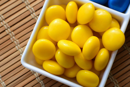 Variety of blue, red, green, yellow multicolored candies displayed in containers
