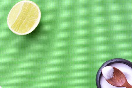 (Citrus - latifolia, the Persian lemon, whole and in pieces tahiti lemons accompanied by salt with an intense greenの写真素材