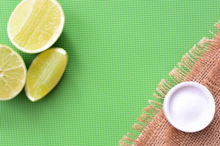 (Citrus - latifolia, the Persian lemon, whole and in pieces tahiti lemons accompanied by salt with an intense greenの写真素材