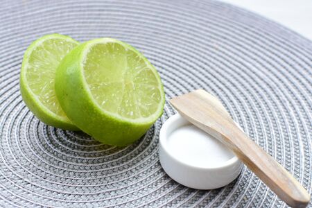 (Citrus - latifolia, the Persian lemon, whole and in pieces tahiti lemons accompanied by salt with an intense greenの写真素材