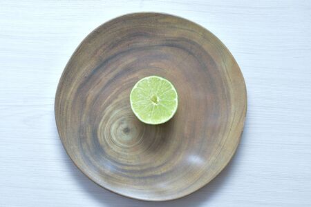 (Citrus - latifolia, the Persian lemon, whole and in pieces tahiti lemons accompanied by salt with an intense greenの写真素材