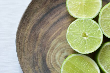 (Citrus - latifolia, the Persian lemon, whole and in pieces tahiti lemons accompanied by salt with an intense greenの写真素材