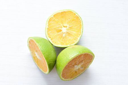 (Citrus - latifolia, the Persian lemon, whole and in pieces tahiti lemons accompanied by salt with an intense greenの写真素材