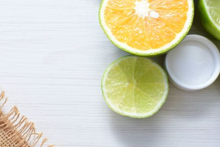 Citrus - latifolia, Persian lemon, Tahiti lemons and whole and diced oranges accompanied by salt with an intense green and yellow greenの写真素材