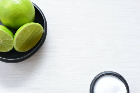 (Citrus - latifolia, the Persian lemon, whole and in pieces tahiti lemons accompanied by salt with an intense greenの写真素材