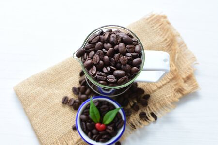 Coffee beans from the mountains of Colombia displayed in containers, watered on a flat backgroundの写真素材