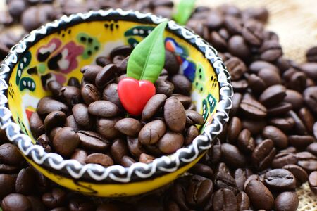 Coffee beans from the mountains of Colombia displayed in containers, watered on a flat backgroundの写真素材