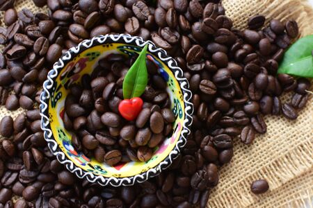 Coffee beans from the mountains of Colombia displayed in containers, watered on a flat backgroundの写真素材