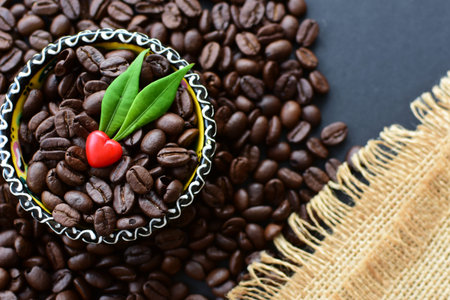 Coffee beans from the mountains of Colombia displayed in containers, watered on a flat background