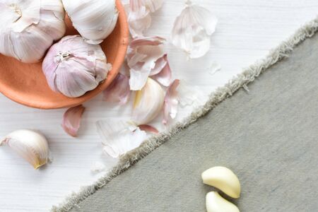 Allium sativum - Whole garlic, minced and shelled displayed in containers on light backgroundsの写真素材