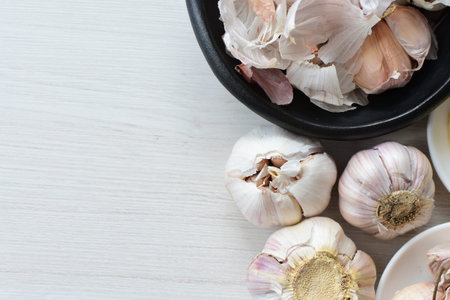 Allium sativum - Whole garlic, minced and shelled displayed in containers on light backgrounds