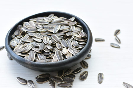 Helianthus annuus - Sunflower seeds displayed in containers with flat-bottomed petals