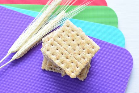 Whole and sliced healthy soda crackers with sesame on flat bottomsの写真素材