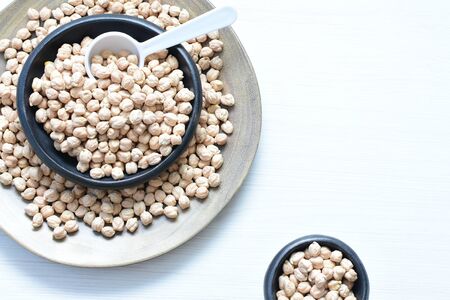 Cicer arietinum - Raw chickpeas displayed in containers watered on flat bottomsの写真素材