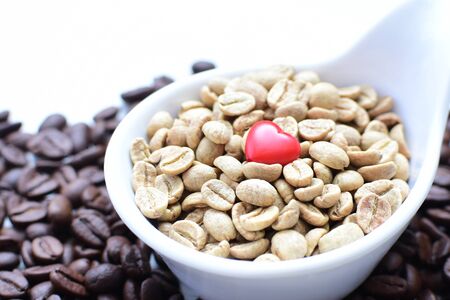 Variety of coffee beans from the mountains of Colombia watered on white backgroundの写真素材