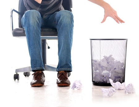 Man throwing a paper into a wastebasketの写真素材