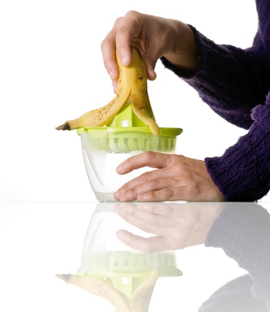 woman hands squeezing a bananaの写真素材