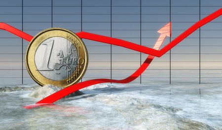 euro coin embedded in a rock on the coastの写真素材