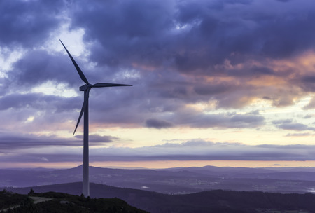 energy concept, sunset and wind turbineの写真素材