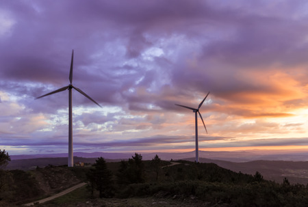 energy concept, sunset and wind turbineの写真素材