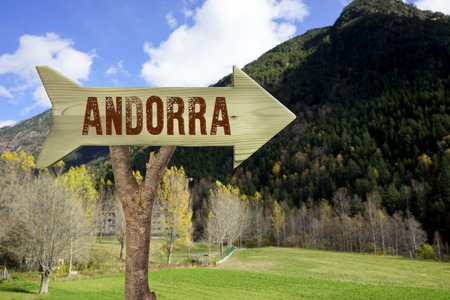 trunk and wooden sign indicating to andorraの写真素材