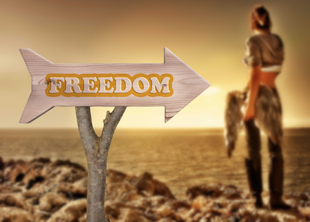 trunk and wooden sign indicating to freedomの写真素材