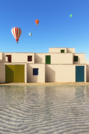facades of houses with white wall and painted wooden doorsの写真素材