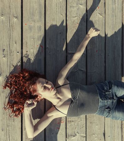 woman lying on the floor stretchingの写真素材