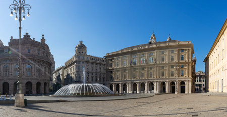 The grand piazza of Genoa basks in the golden morning light, showcasing the splendor of Renaissance architecture. A majestic fountain mirrors the sky, surrounded by ornate buildings that speak of the city's rich cultural pastの写真素材