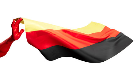 Vivid colors of Germany's flag captured mid-wave by a graceful hand, set against a dark backdropの写真素材