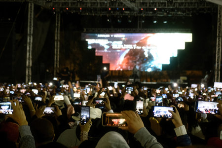 Many people with phone on stage