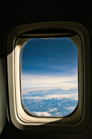View of blue cloudy sky from airplane windowの写真素材