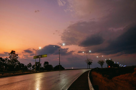 A Road illuminated by lamps in beautiful sunsetの写真素材