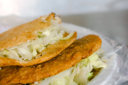 A Mexican food gorditas fried in oil, of meat crumbs and cheeseの写真素材