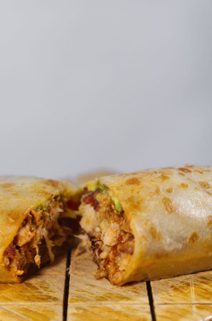 A Pastor mexican burrito with meat and hot sauce
