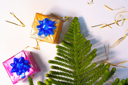 A Christmas decorations with spheres gifts and pine needles with space for text and shiny backgroundの写真素材