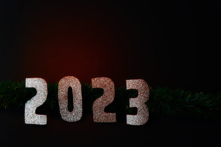 A Happy New Year 2023. Golden numbers on a black background with glitter