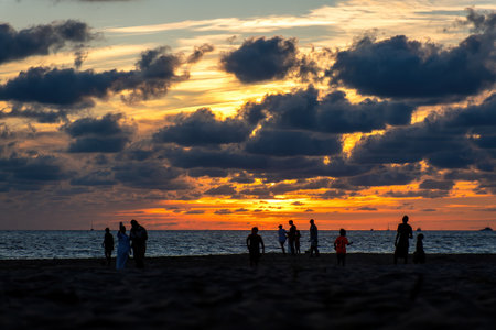 A Family playing on the beach at beautiful sunset with sunsetの写真素材