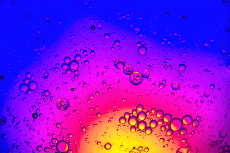 A colorful background with water drops and a yellow and blue backgroundの写真素材