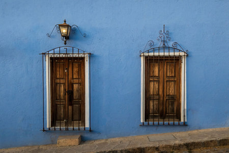 A blue Mexican old rustic house with a lamp in the front.の写真素材