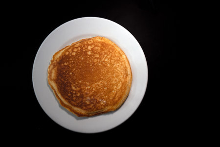 A Traditional Hot Cake with black background and space for advertising textの写真素材