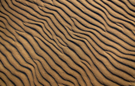 A Sand dunes with a wind created pattern on the beach background