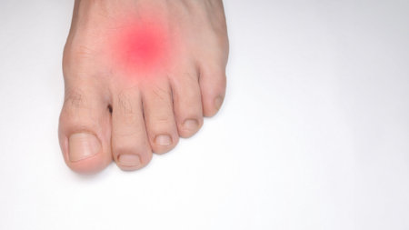 A Close up of the instep of a person left foot with a red mark representing pain