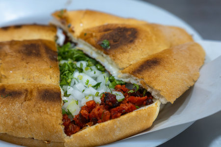 Delicious Torta de Carne de Pastor with savory marinated meat, fresh cilantro, and chopped onions...